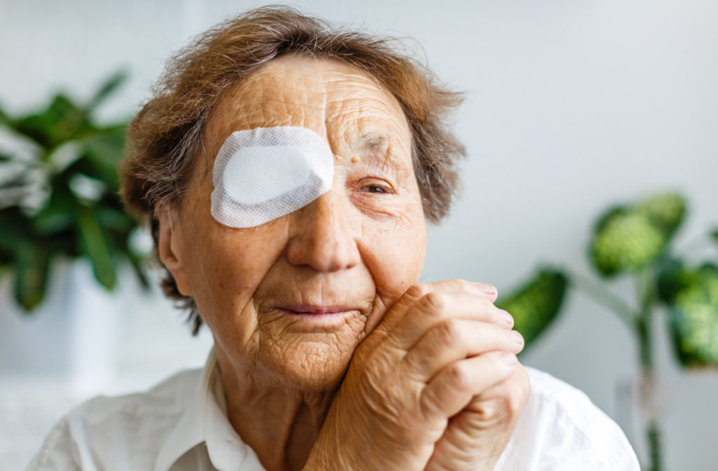 An older woman is using an eye patch after cataract surgery.