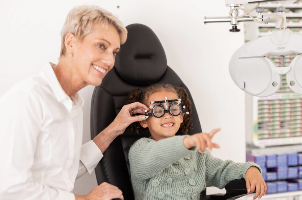  An optometrist assesses their young patient's myopia progression during their comprehensive eye exam.