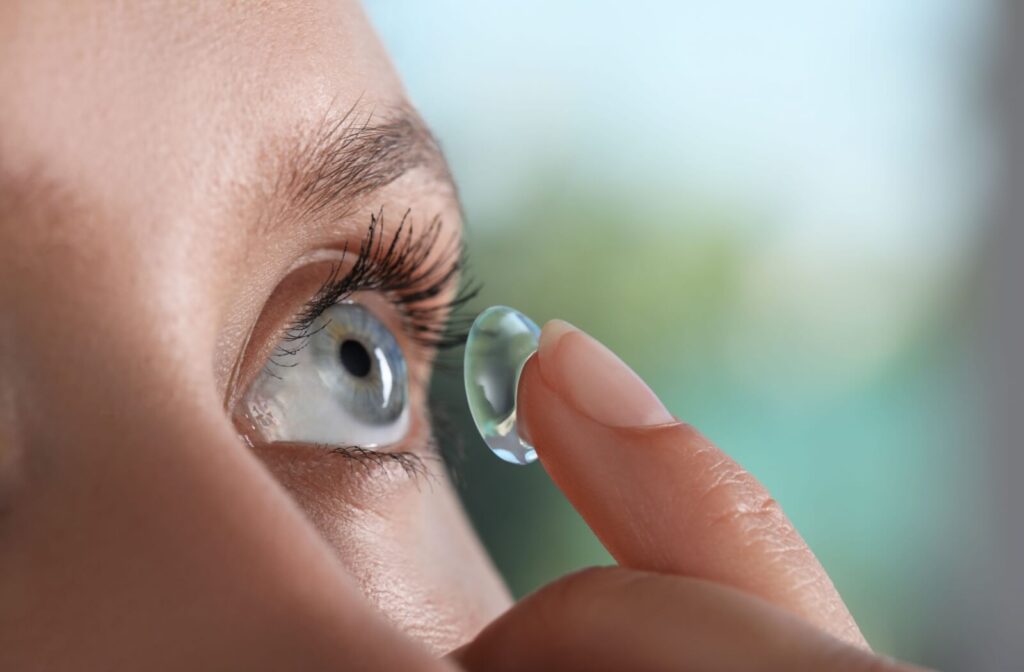 Someone putting a contact lens into their eye.