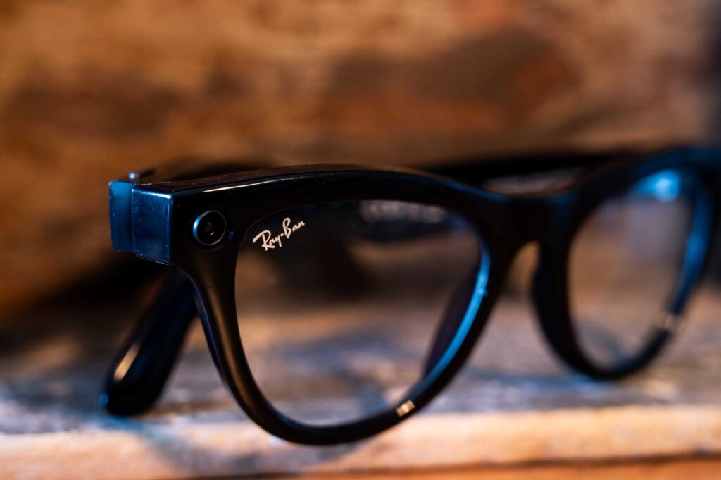 A close-up of the cat-eye frame style from the Ray-Ban Meta smart glasses collection, featuring a glossy black finish and the iconic white Ray-Ban logo on the lens.